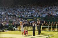 Andy Murray of Britain holds the winners trophy after defeating Novak Djokovic of Serbia in their men's singles final tennis match at the Wimbledon Tennis Championships, in London