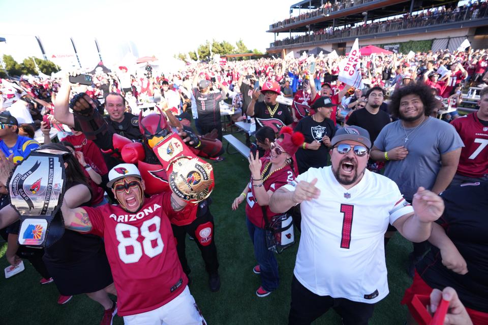 Fans celebrate the Arizona Cardinals pick of Marvin Harrison Jr. during an NFL Draft party at State Farm Stadium Great Lawn in Glendale on April 25, 2024.