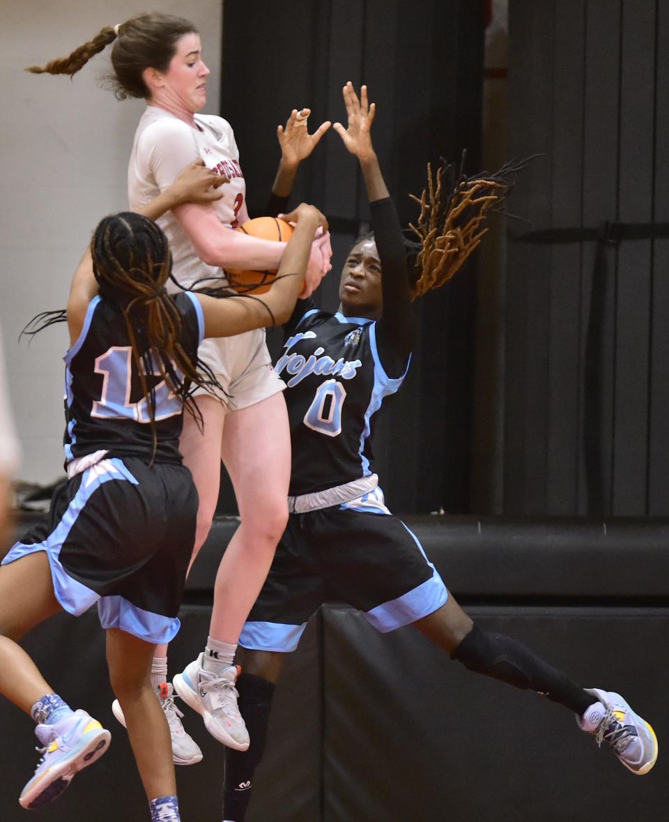 Bishop Kenny forward Clare Coyle (2) battles two Ribault defenders for a rebound. Coyle averages 9 rebounds and 1.7 blocks per game.