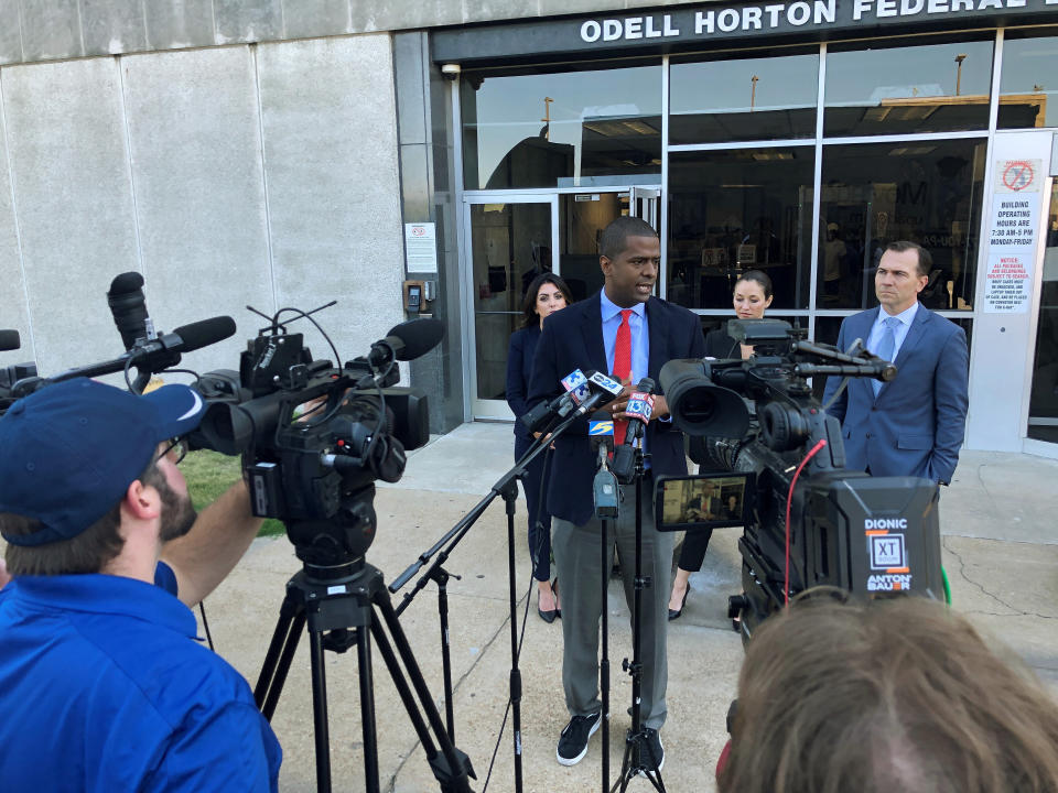 Attorney Bakari Sellers, center, speaks with reporters during a news conference announcing a cheerleading abuse lawsuit filed in Tennessee on Tuesday, Sept. 27, 2022, in Memphis, Tenn. (AP Photo/Adrian Sainz)