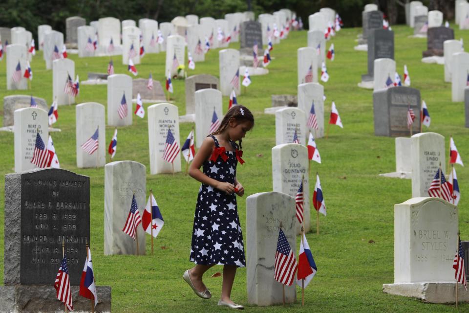 Girl walks through the Corozal American Cemetery during a ceremony honouring Veterans Day in Panama City