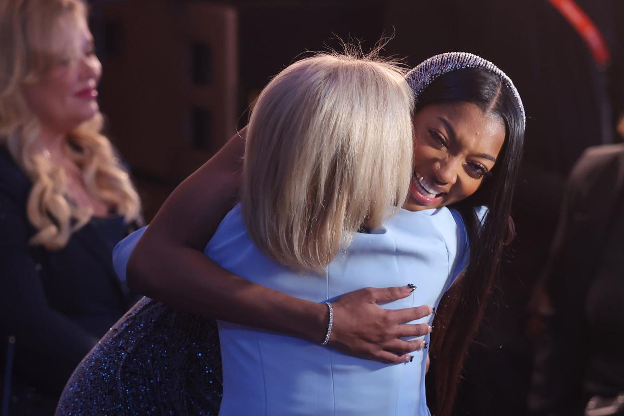 Angel Reese embraces LSU coach Kim Mulkey after she is selected with the number seven overall pick by the Chicago Sky in the 2024 WNBA draft.