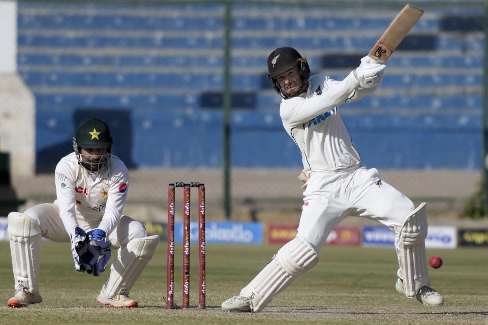 New Zealand's Tom Blundell, right, plays a shot as Pakistan's Sarfraz Ahmed watches during the fourth day of the second test cricket match between Pakistan and New Zealand, in Karachi, Pakistan, Thursday, Jan. 5, 2023. (AP Photo/Fareed Khan)