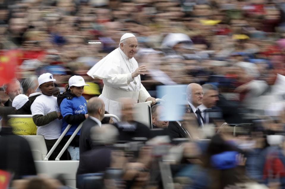 Pope Francis rides with a group of migrant children who recently arrived from Libya, on his popemobile at the start of his weekly general audience in St. Peter's Square, at the Vatican, Wednesday May 15, 2019. (AP Photo/Andrew Medichini)