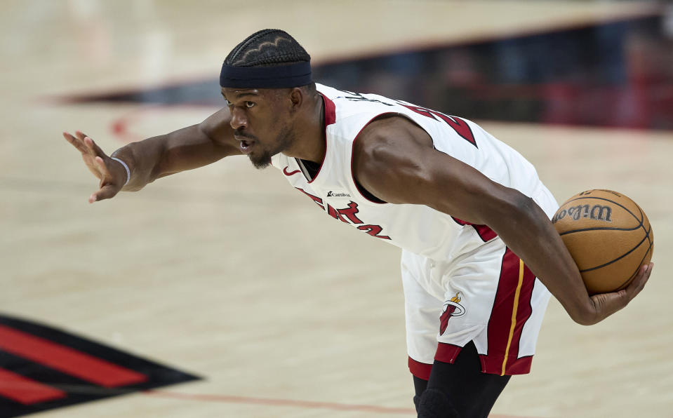 Miami Heat forward Jimmy Butler holds the ball against the Portland Trail Blazers during the first half of an NBA basketball game in Portland, Ore., Tuesday, Feb. 27, 2024. (AP Photo/Craig Mitchelldyer)