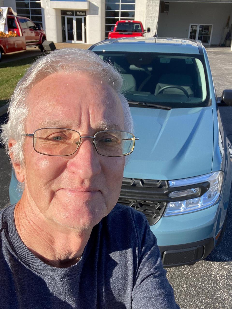 Steve Thomson, 69, is a Ford shareholder who retired as a parts manager at Koetting Ford in Granite City, Illinois, in 2016. He is seen here at Festus Ford in Herculaneum, Missouri on Oct. 21, 2021 with a 2022 Ford Maverick painted Area 51 gray. He loves the compact pickup.