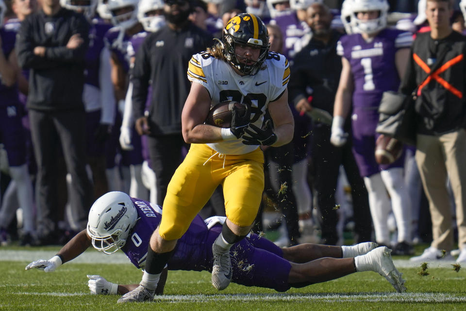 Iowa fullback Hayden Large (88) carries the ball and avoids Northwestern defensive back Coco Azema (0) during the first half of an NCAA college football game Saturday, Nov. 4, 2023, at Wrigley Field in Chicago. (AP Photo/Erin Hooley)