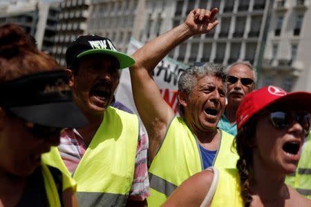 Municipal workers shout slogans in front of the parliament building during a rally against job layoffs in Athens, Greece, June 29, 2017. REUTERS/Costas Baltas