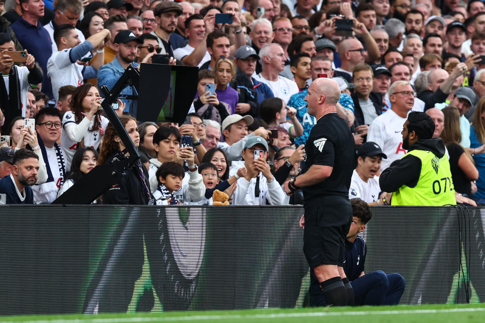 Referee Simon Hooper consults VAR during the Premier League match between Tottenham Hotspur and Liverpool on Sept. 30 in London. (Charlotte Wilson/Offside via Getty Images)