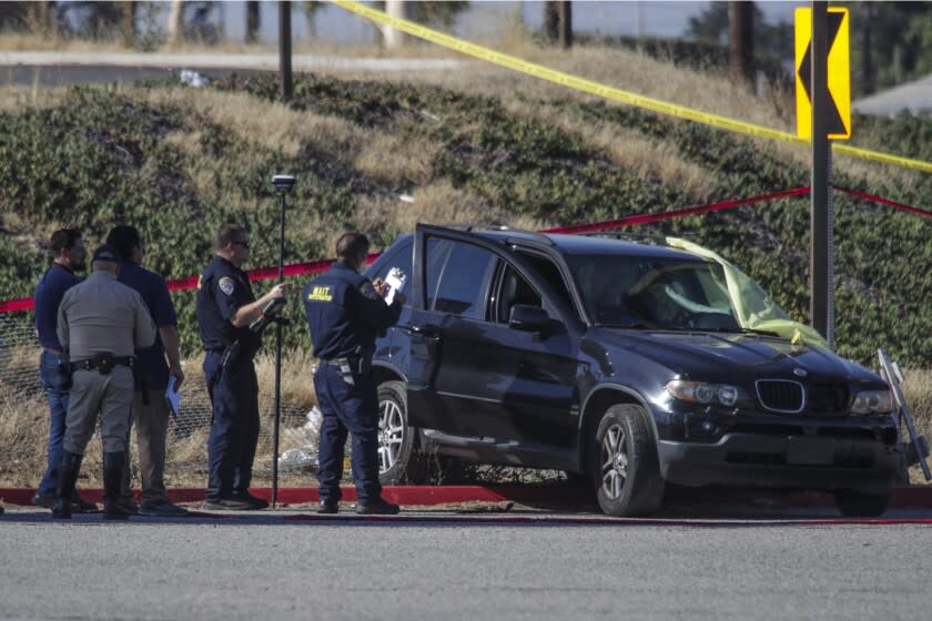Long Beach, CA - June 28: An investigation is underway after a woman was shot and killed while driving a black BMW SUV on the 710 Freeway and then crashed along the Anaheim Street off-ramp on Tuesday, June 28, 2022 in Long Beach, CA. (Irfan Khan / Los Angeles Times)
