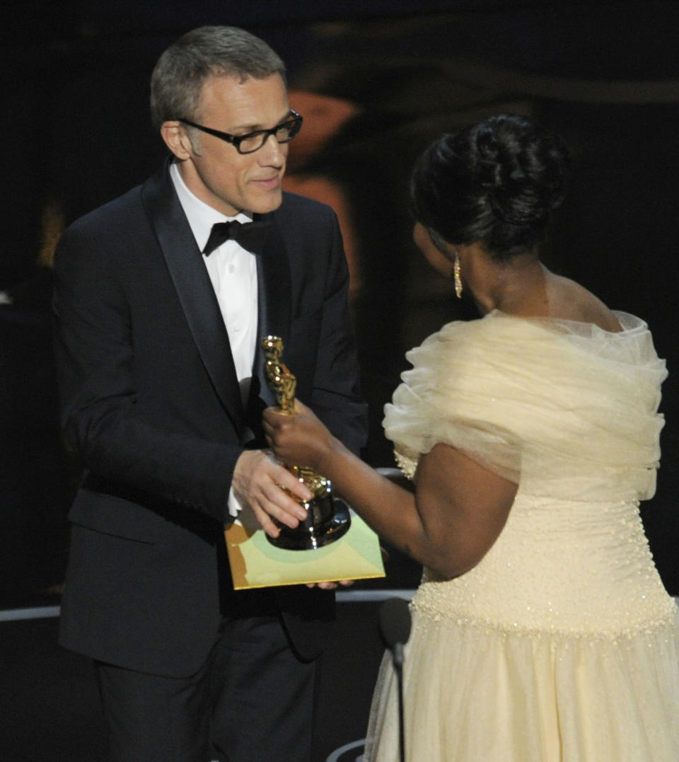 Actress Octavia Spencer, right, presents the award for best actor in a supporting role for "Django Unchained" to Christoph Waltz during the Oscars at the Dolby Theatre on Sunday Feb. 24, 2013, in Los Angeles. (Photo by Chris Pizzello/Invision/AP)