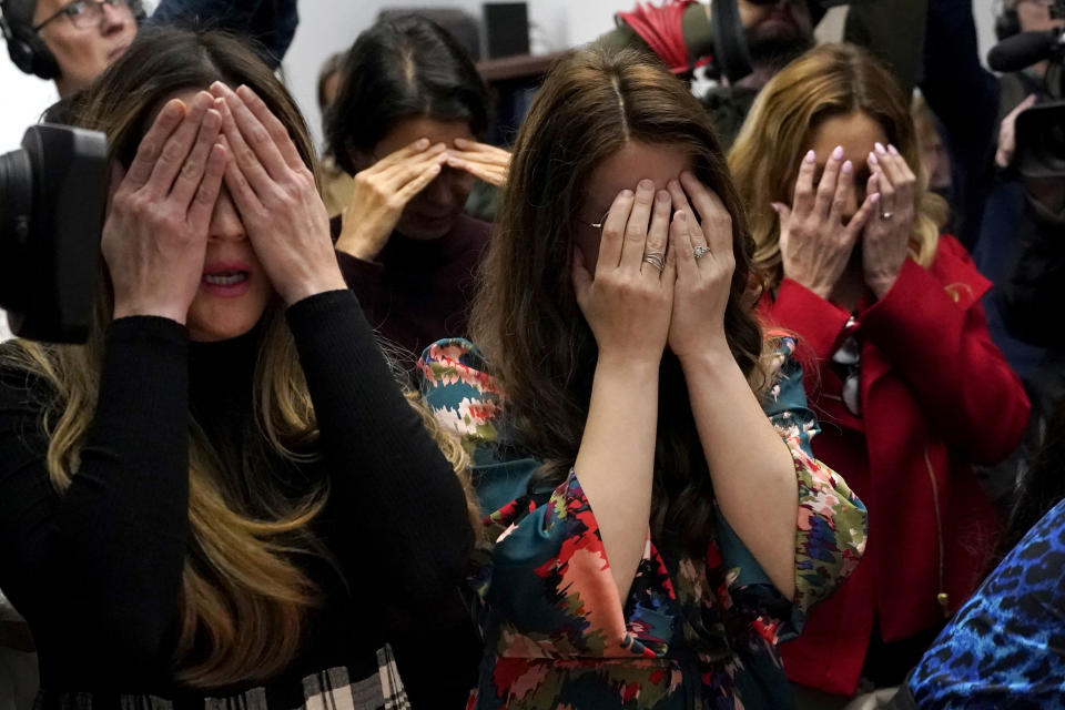 Members of the Chabad of Evanston, Ill., where Judith Raanan attended, cover their eyes as they pray at the beginning of Shabbat on Friday, Oct. 20, 2023, in Evanston. Raanan and her daughter Natalie were released Friday from their captivity in Gaza. (AP Photo/Charles Rex Arbogast)