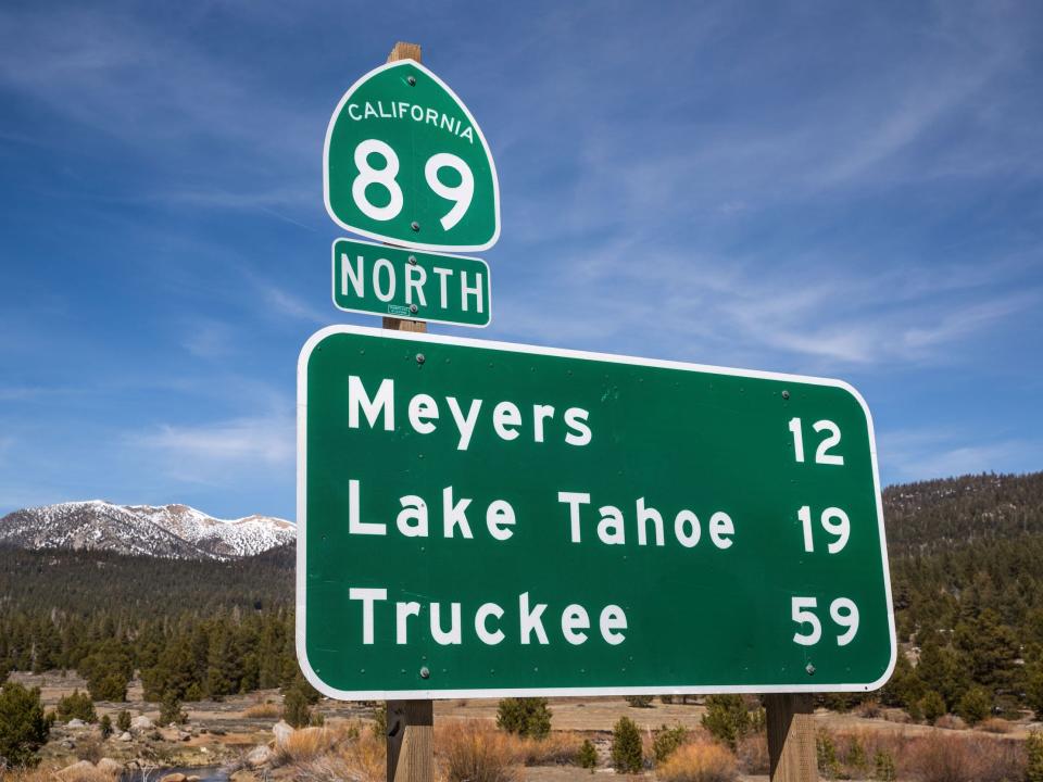 A highway sign reporting the number of miles to Lake Tahoe, Meyers, and Truckee