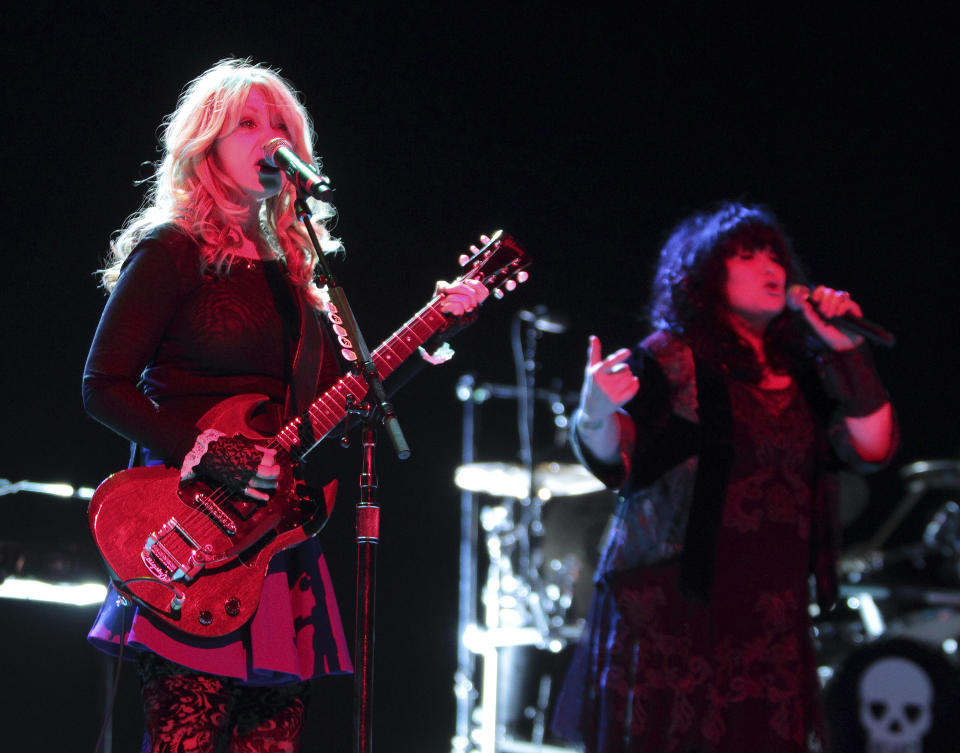 FILE - Nancy and Ann Wilson of the classic rock band Heart perform in concert at the American Music Theater on Monday, March 24, 2014, in Lancaster, Pa. Heart — the pioneering band that melds Nancy Wilson’s shredding guitar with her sister Ann’s powerhouse vocals — is hitting the road this spring for a world tour that Nancy Wilson describes as “the full-on rocker size.” (Photo by Owen Sweeney/Invision/AP, File)