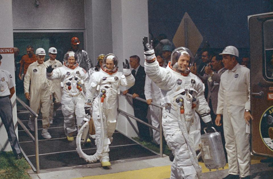 n this July 16, 1969 file photo, Neil Armstrong waving in front, heads for the van that will take the crew to the rocket for launch to the moon at Kennedy Space Center in Merritt Island, Fla. Armstrong commanded the Apollo 11 spacecraft that landed on the moon July 20, 1969.