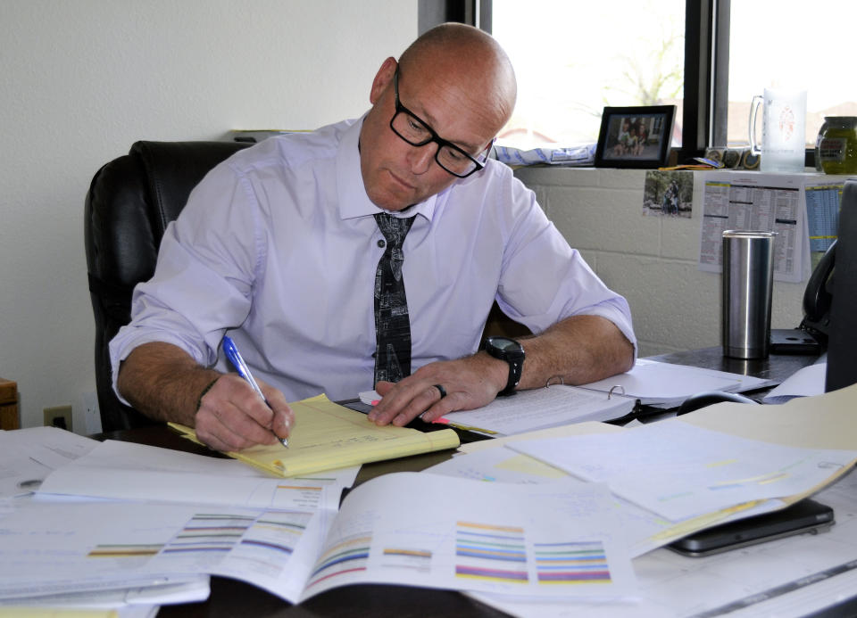 This photo provided by the Yavapai County Sheriff's Office shows Lt. Victor Dartt working from his office in Prescott, Ariz., on April 21, 2021. Dartt led the investigation into the 1988 death of Pamela Pitts, whose then-roommate, Shelly Harmon, confessed to the killing in March 2021 after already having served time for the 1991 death of an ex-boyfriend. (Yavapai County Sheriff's Office via AP)