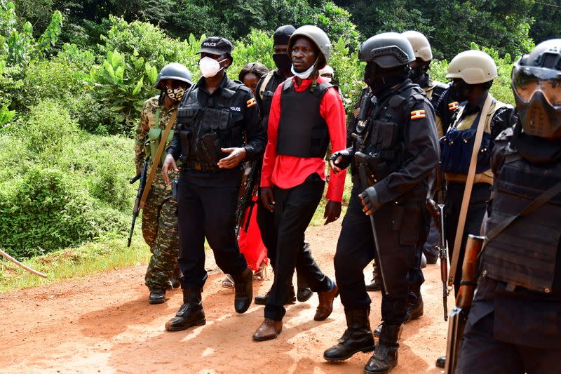 Uganda opposition presidential candidate Robert Kyagulanyi is escorted by police in Kalangala