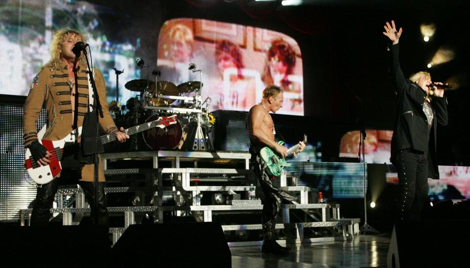 Rick Savage, from left, Phil Collen and Joe Elliott of Def Leppard on stage at the PNC Bank Arts Center in Holmdel in 2009. Photo by Mary Frank.