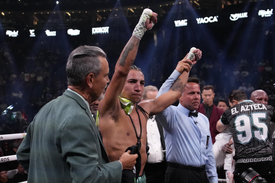 Mario Barrios celebrates defeating Yordenis Ugas after their welterweight boxing match Saturday, Sept. 30, 2023, in Las Vegas. (AP Photo/John Locher)