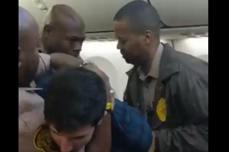 Arrest: A video filmed on the plane showed three officers attempting to detain the passenger before he was tasered: Twitter