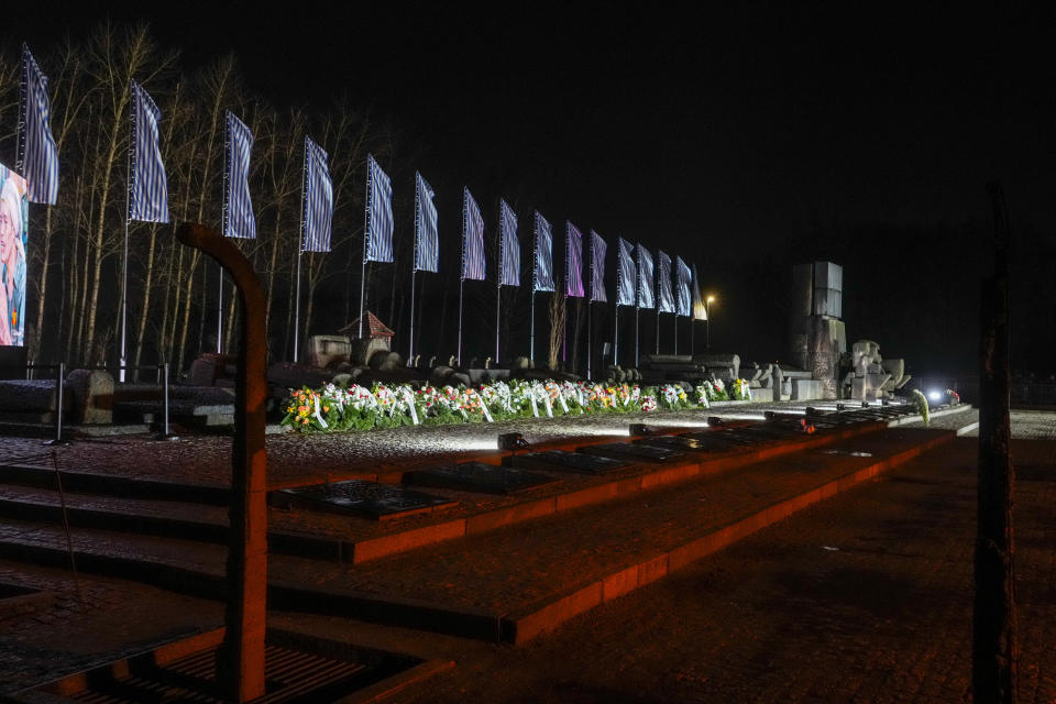 Flowers are placed by the memorial monument at the Birkenau Nazi death camp in Oswiecim, Poland, Saturday, Jan. 27, 2024. Survivors of Nazi death camps marked the 79th anniversary of the liberation of the Auschwitz-Birkenau camp during World War II in a modest ceremony in southern Poland.(AP Photo/Czarek Sokolowski)