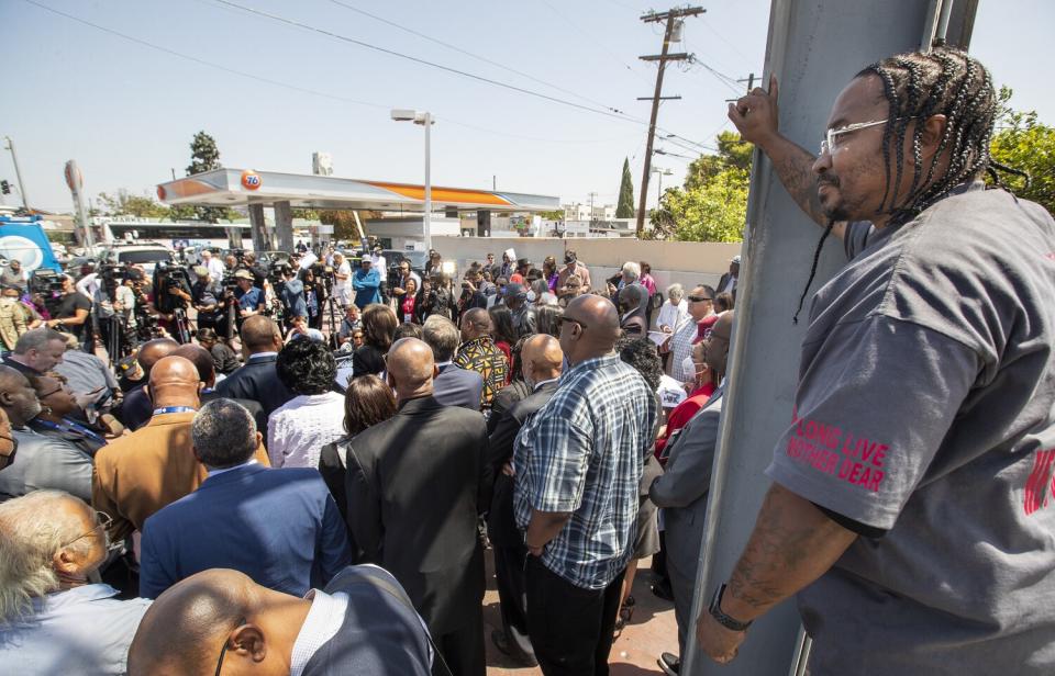 Pastor Tyrice Cagle is perched above a crowd.