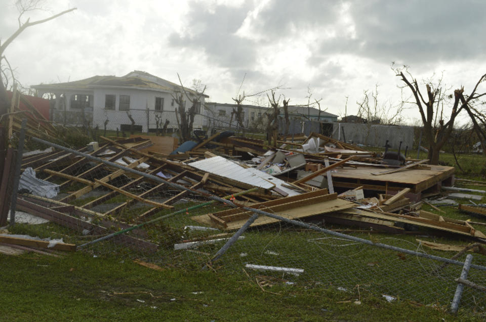 FILE - In this Thursday, Sept. 7, 2017, photo, damage is left after Hurricane Irma hit Barbuda. When Hurricane Irma slammed into the tiny Caribbean island as a powerful Category 5 storm in 2017, the government temporarily evacuated the entire population of some 1,600. Before many of them had trickled back, U.S. developers were allowed in and permitted to build an airport and luxury resort, a project that has angered islanders and that the U.N. warns is a danger to a wetland and other fragile environments. (AP Photo/Anika E. Kentish, File)