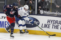 Tampa Bay Lightning's Erik Cernak, right, keeps the puck away from Columbus Blue Jackets' Liam Foudy during the second period of an NHL hockey game Thursday, Jan. 21, 2021, in Columbus, Ohio. (AP Photo/Jay LaPrete)