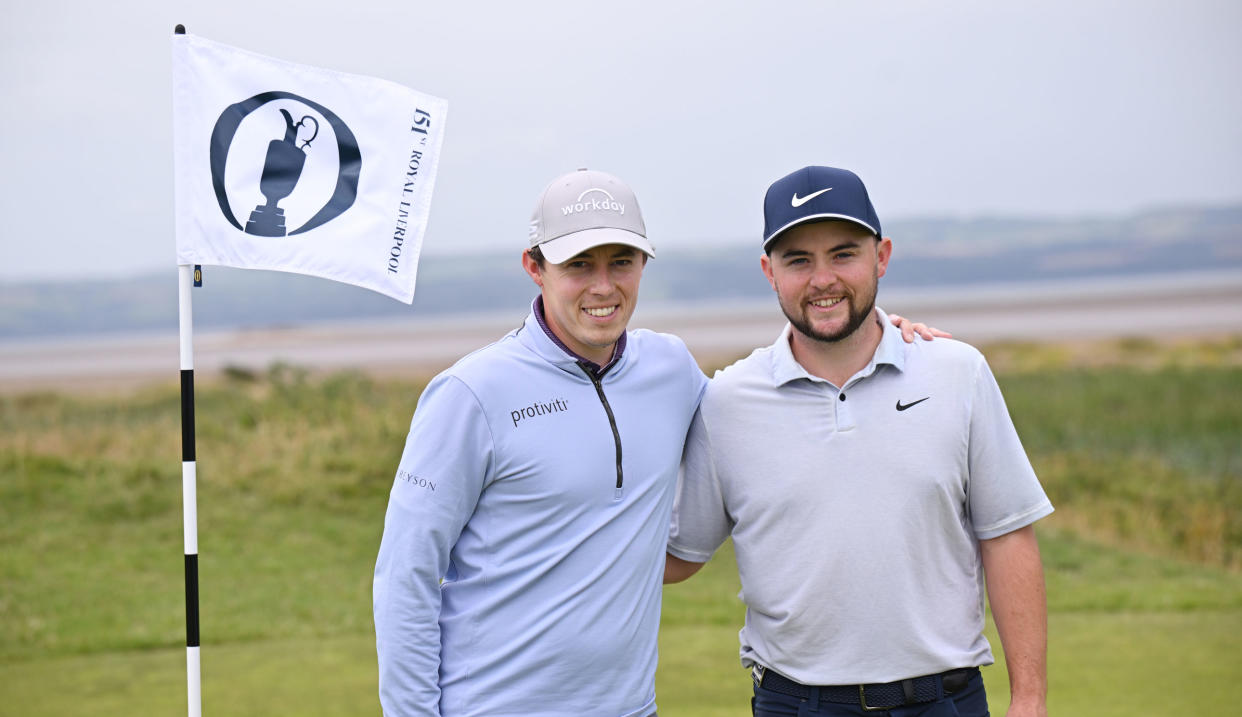  Matt and Alex Fitzpatrick pose next to an Open Championship flag  