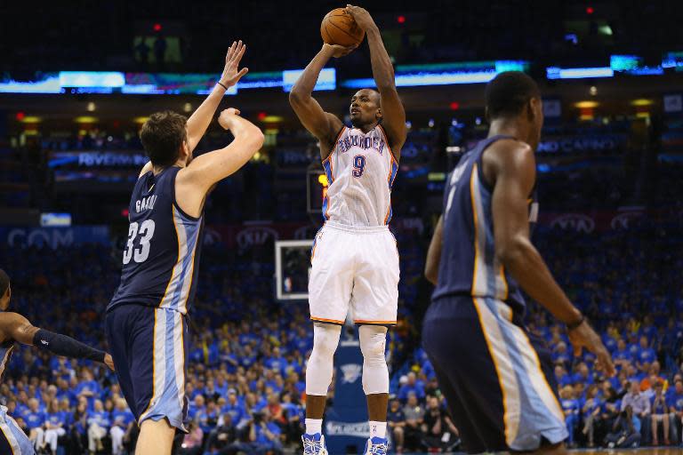 Serge Ibaka of the Oklahoma City Thunder takes a shot against Marc Gasol of the Memphis Grizzlies in Game One of the Western Conference Quarterfinals during the 2014 NBA Playoffs at Chesapeake Energy Arena on April 19, 2014 in Oklahoma City