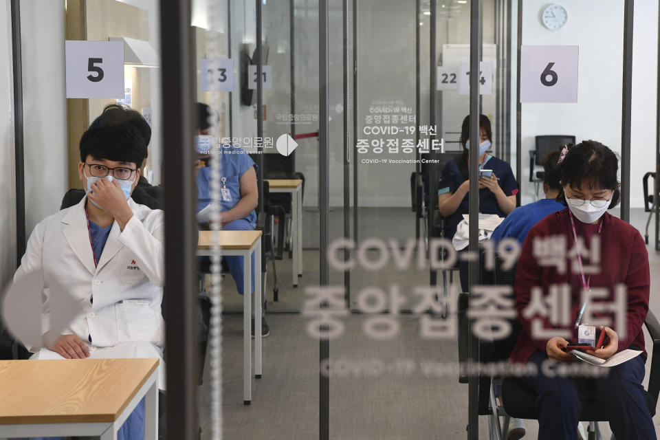 Medical workers wait to receive the first dose of the Pfizer BioNTech COVID-19 vaccine at the National Medical Center vaccination center in Seoul Saturday, Feb. 27, 2021. (Song Kyung-Seok/Pool Photo via AP)