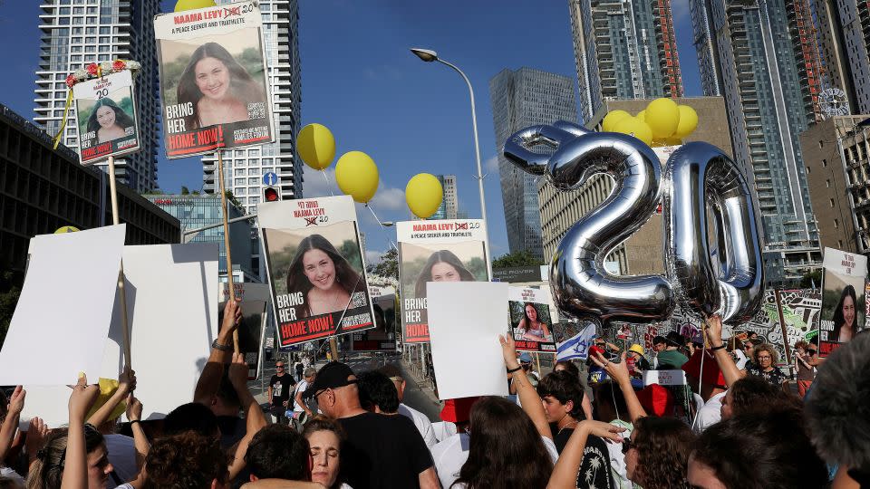 People hold up signs and balloons as family, friends and supporters of Israeli hostage Naama Levy, who was kidnapped during the deadly October 7 attack, take part in a protest march marking what would have been her 20th birthday in Tel Aviv, June 22, 2024. - Eloisa Lopez/Reuters