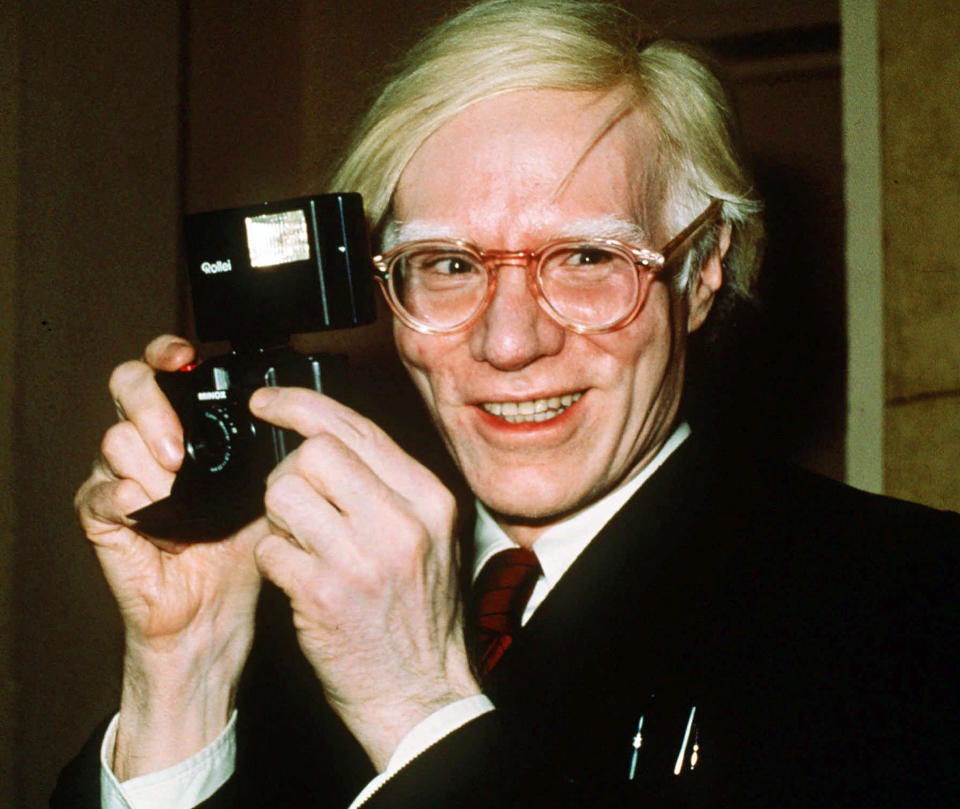 FILE - In this 1976 file photo, pop artist Andy Warhol smiles in New York. A federal appeals court sided with a photographer Friday, March 26, 2021, in her copyright dispute over how a foundation has marketed a series of Andy Warhol works of art based on her pictures of Prince. (AP Photo/Richard Drew, File)