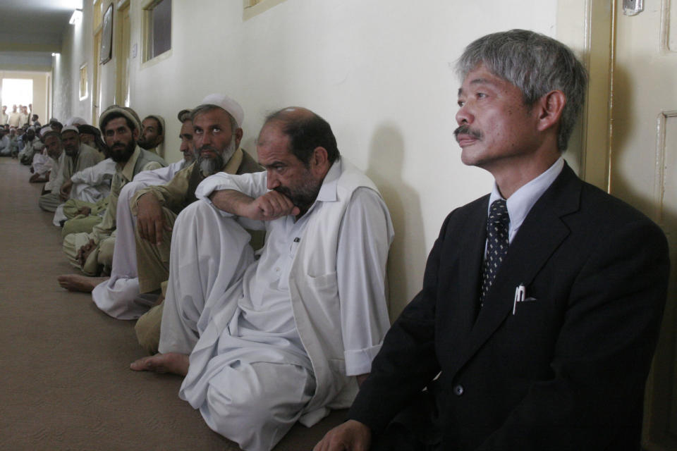 FILE - In this Thursday, Aug 28, 2008, file photo, Tetsu Nakamura, right, executive director of PMS Japan, participates in the memorial service for Japanese aid worker Kazuya Ito at the governor's house in Jalalabad, east of Kabul, Nangarhar province, Afghanistan. The Japanese physician and aid worker in eastern Afghanistan died of his wounds after an attack Wednesday, Dec. 4, 2019, that also killed five Afghans, including the doctor’s bodyguards, the driver and a passenger, a hospital spokesman said. (AP Photo/Rahmat Gul, File)