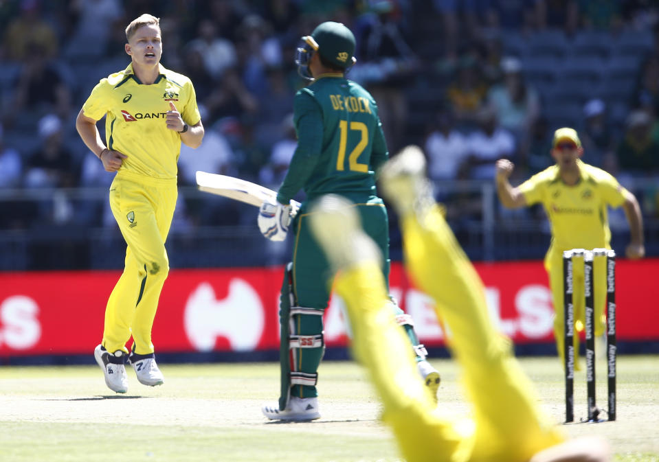 Australia's Nathan Ellis, left, celebrates the wicket of South Africa's Quinton de Kock during the fifth and final ODI cricket match between South Africa and Australia at the Wanderers Stadium in Johannesburg, South Africa, Sunday, Sept. 17, 2023. (AP Photo)