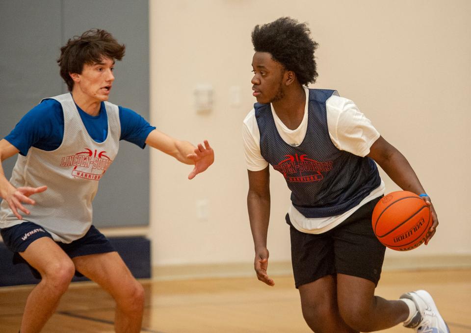 Lincoln-Sudbury junior Jojo Jean Pierre, right, guarded by sophomore Paul Conway, at practice, Jan. 12, 2023.