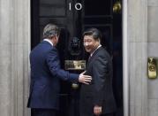 China's President Xi Jinping looks back as he is welcomed by Britain's Prime Minister David Cameron to 10 Downing Street, in central London, Britain, October 21, 2015. Xi is on a state visit to Britain. REUTERS/Toby Melville