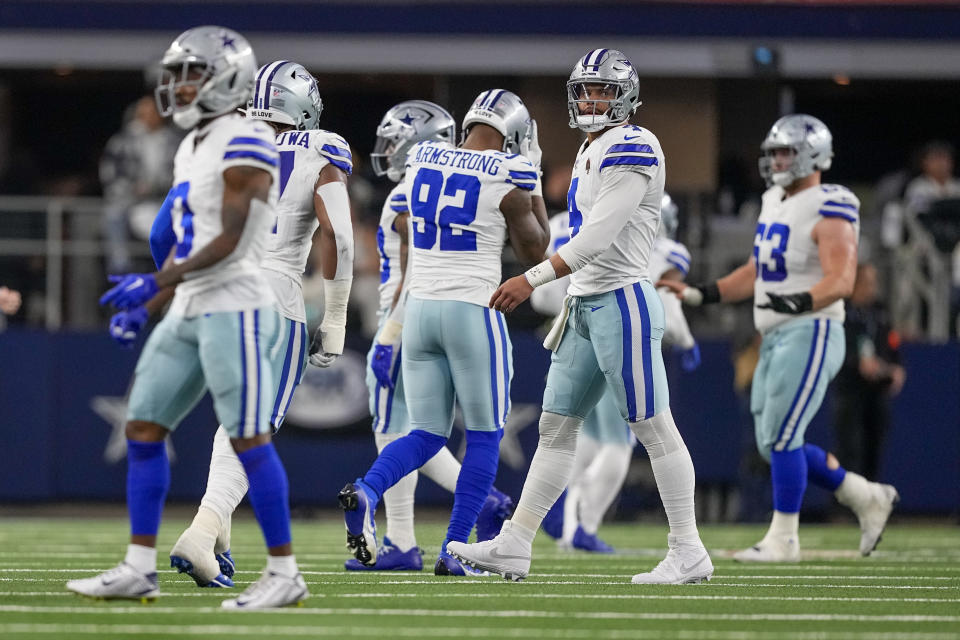 Dallas Cowboys quarterback Dak Prescott, second from right, heads to the bench after his pass was intercepted and returned for a touchdown by Green Bay Packers safety Darnell Savage during the first half of an NFL football game, Sunday, Jan. 14, 2024, in Arlington, Texas. (AP Photo/Sam Hodde)