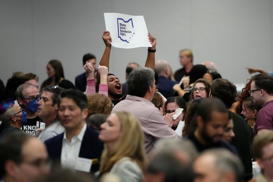 Nov 7, 2023; Columbus, Ohio, USA; Supporters of Issue 1 react to the projected passage of the issue during a gathering for the issue at the Hyatt Regency Downtown. The issue establishes a constitutional right to abortion.