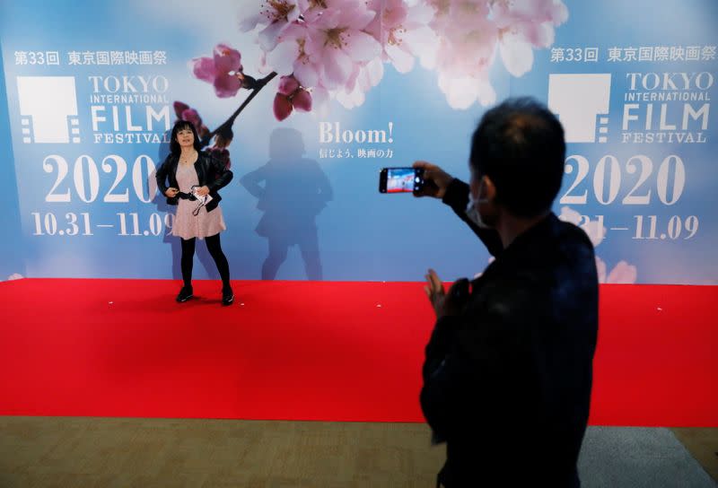 Visitors take photo on the red carpet at an entrance gate of the the 33rd Tokyo International Film Festival, amid the coronavirus disease (COVID-19) outbreak, in Tokyo