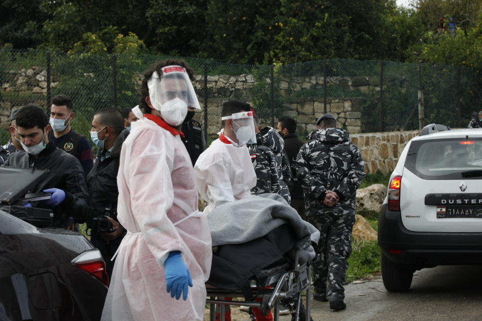 Lebanese Red Cross volunteers transport the body of Lokman Slim, a longtime Shiite political activist and researcher, found dead in his car in Addoussieh village, in the southern province of Nabatiyeh, Lebanon, Thursday, Feb. 4, 2021. (AP Photo/Mohammed Zaatari)