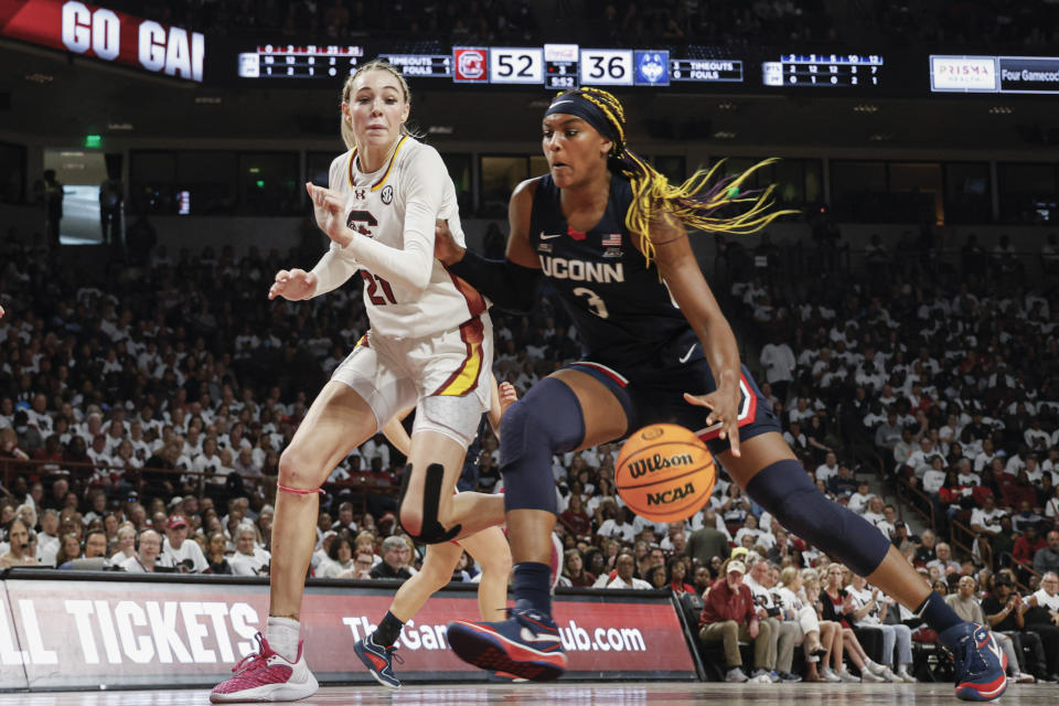 UConn forward Aaliyah Edwards, right, drives to the basket against South Carolina forward Chloe Kitts, left, during the second half of an NCAA college basketball game in Columbia, S.C., Sunday, Feb. 11, 2024. (AP Photo/Nell Redmond)