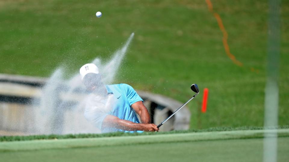 Tim Darby/For The Times-Union --5/8/15 --  Tiger Woods hits out of the bunker off the 18th green. He salvaged par on the hole. Second Round of The Players Championship at TPC Sawgrass Players Stadium Course in Ponte Vedra Beach, FL on Friday May 8, 2015.  (The Florida Times-Union, Tim Darby)