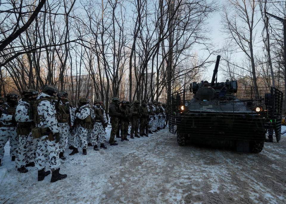 Service members take part in tactical exercises, which are conducted by the Ukrainian National Guard, Armed Forces, special operations units and simulate a crisis situation in an urban settlement, in the abandoned city of Pripyat near the Chernobyl Nuclear Power Plant, Ukraine, February 4, 2022. REUTERS/Gleb Garanich
