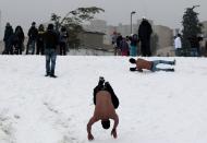 People play in the snow following a snowstorm at a park in Jerusalem December 14, 2013. Jerusalem's heaviest snow for 50 years forced Israeli authorities to lift a Jewish sabbath public transport ban on Saturday and allow trains out of the city where highways were shut to traffic. REUTERS/ Ammar Awad (JERUSALEM - Tags: ENVIRONMENT)