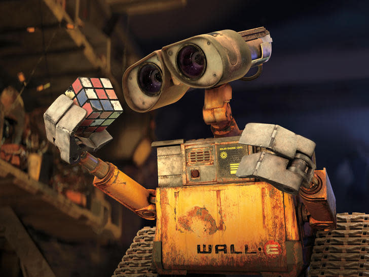 WALL-E ponders a Rubik's Cube on a desolate future Earth