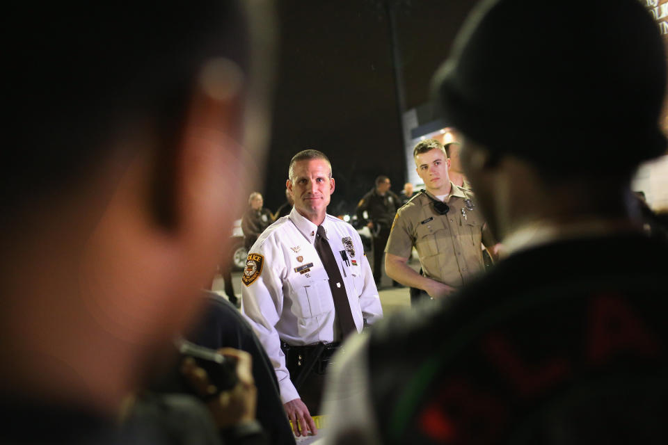 Demonstrators protests in front of the police station on March 12, 2015 in Ferguson, Missouri. Two police officers were shot yesterday while standing outside the station observing a similar protest. Ferguson has faced many violent protests since the August shooting death of Michael Brown by a Ferguson police officer.