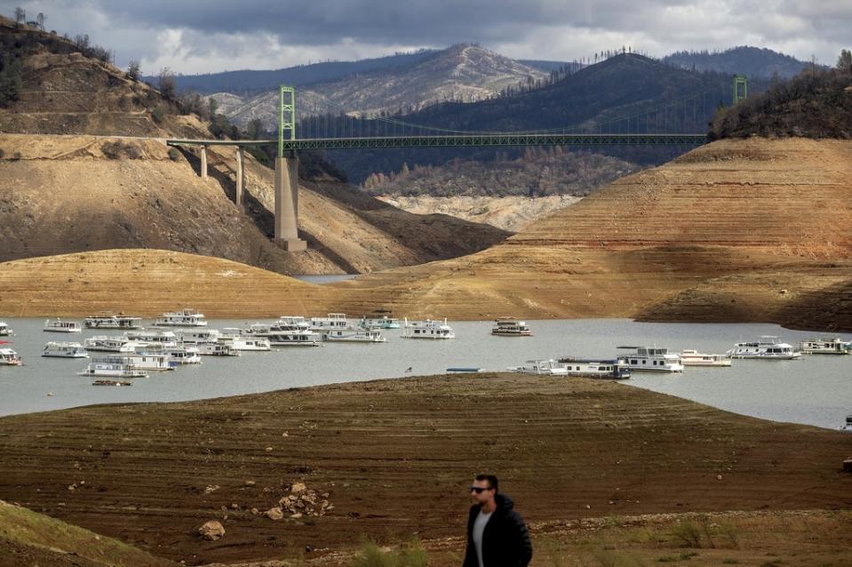 FILE – Houseboats float on Lake Oroville on Oct. 25, 2021, in Oroville, Calif. Months of winter storms have replenished California’s key reservoirs after three years of punishing drought. (AP Photo/Noah Berger, File )