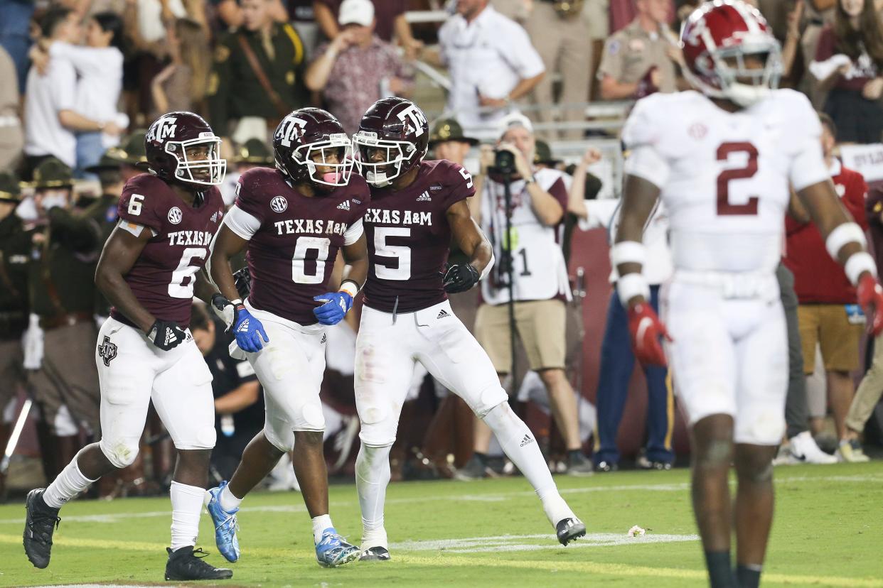 Aggies RB Devon Achane (6) and WR Jalen Preston (5) celebrate Ainias Smith's touchdown against Alabama in the fourth quarter.