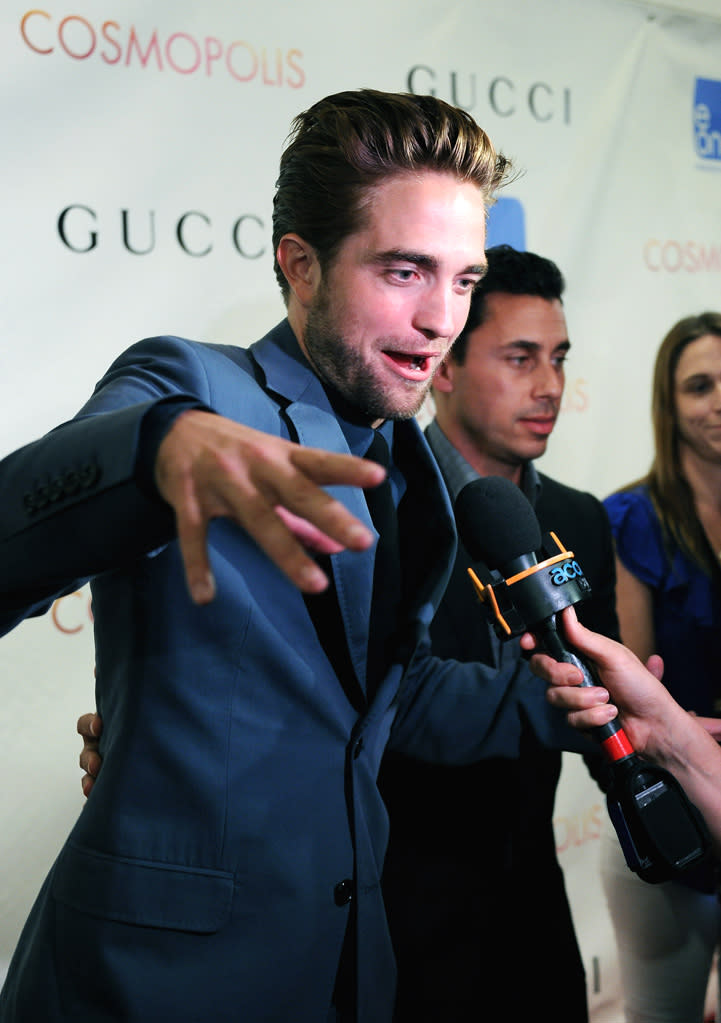 Robert Pattinson gets animated as he chats with reporters during the New York City premier of "Cosmopolis" on August 13, 2012.